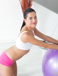 There are many ways of keeping fit. Some girls adore jogging, others go to a gym and this yummy brunette adores working out with a fitball. She performs several exercises and then asks coach for help. He shows her new ways of improving her flexibility and strength. View of a beautiful babe in a tiny top and pink panties turns him on to such a limit that he simply has to check her pussy with his fingers. He even fills her sweet mouth with natural protein in the end of the sex workout.